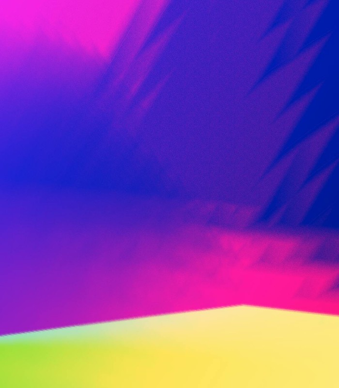 Colorful abstract gradient background with vibrant hues of pink, purple, and yellow.